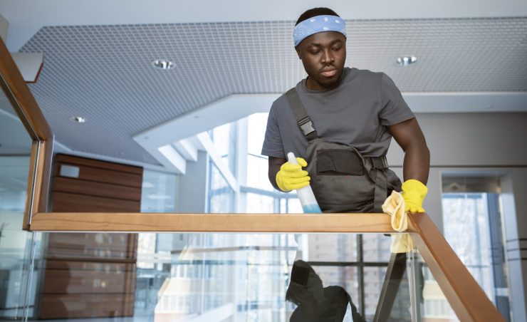 man-cleaning-railing-medium-shot
